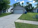 A quaint single-Gathering home featuring a two-car garage and an easy to maintain landscape at 3861 Candle Berry Dr, Indianapolis, IN 46235