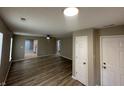Bright, open-concept living room featuring wood floors and neutral paint throughout at 3861 Candle Berry Dr, Indianapolis, IN 46235