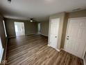 Spacious living room featuring modern wood flooring and open access to other areas of the home at 3861 Candle Berry Dr, Indianapolis, IN 46235