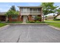 Inviting brick home with balcony and well-kept greenery, offering comfortable living at 3975 Offshore Dr, Columbus, IN 47203