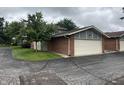 View of the attached garage featuring a brick exterior and well-maintained surroundings at 3975 Offshore Dr, Columbus, IN 47203