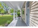 View of the covered porch featuring a painted deck, side house view, and a lovely exterior view at 420 Vista Dr, Carmel, IN 46280
