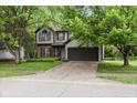 Charming two-story home with gray siding, brick accents, and a well-manicured front yard at 4736 Rocky Knob Ln, Indianapolis, IN 46254