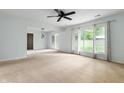 Spacious living room with large windows and a sliding glass door to the outside at 4904 N Tillotson Ave, Muncie, IN 47304