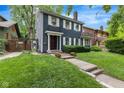 A classic two story exterior elevation showing the walkway and lush yard at 519 Woodruff Place Middle Dr, Indianapolis, IN 46201
