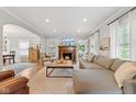 Open living room with a fireplace, large sectional sofa, and hardwood floors at 519 Woodruff Place Middle Dr, Indianapolis, IN 46201