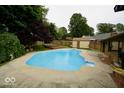 Large backyard pool with a deck, privacy fence, and storage shed at 5331 Birch Ln, Greenwood, IN 46143