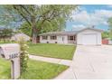Street view of home showing well-manicured lawn, white siding, and updated mailbox at 5602 Northport Dr, Indianapolis, IN 46221