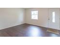 Clean, modern living room featuring hardwood floors, fresh paint, and natural light at 5602 Northport Dr, Indianapolis, IN 46221