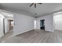 Spacious living room with wood-look floors, neutral paint, and vaulted ceiling at 5633 Fox Glove Ln, Indianapolis, IN 46254