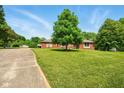 This single Gathering home has a long driveway and a large manicured lawn at 564 Penright Ct, Indianapolis, IN 46217