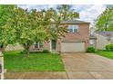 Charming two-story brick home with a well-maintained lawn and a two-car garage at 5737 Arlington Dr, Plainfield, IN 46168