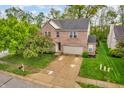Beautifully landscaped two-story brick home with mature tree and two car garage at 5737 Arlington Dr, Plainfield, IN 46168