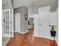 Inviting foyer with beautiful hardwood floors and a view into the living room at 5737 Arlington Dr, Plainfield, IN 46168