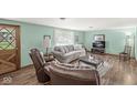 Inviting living room with stylish furniture, wood door, and natural lighting at 5889 W Homestead Dr, Frankton, IN 46044