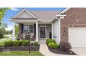 Inviting front porch featuring comfortable seating, beautiful landscaping, and a cozy entrance at 589 Viking Warrior Blvd, Westfield, IN 46074