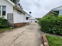 Spacious driveway leading to a detached garage and backyard at 621 E 31St St, Anderson, IN 46016