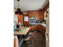 Vintage style kitchen with warm wood cabinets, matching table and retro accents at 621 E 31St St, Anderson, IN 46016