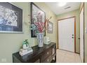 Inviting entryway with tiled flooring, decorative table, and stylish artwork creating a warm welcome at 6627 Cobden Ct, Indianapolis, IN 46254