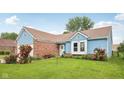 Charming single Gathering home with blue siding, brick accents, well-maintained landscaping, and a grassy front yard at 6627 Cobden Ct, Indianapolis, IN 46254