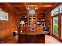 Sophisticated wood paneled office with custom built-ins, detailed trim, and cozy lighting at 6630 Travis Rd, Greenwood, IN 46143