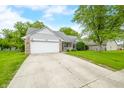 Charming single-story home with a well-manicured lawn and a welcoming porch at 6737 Raritan Dr, Indianapolis, IN 46221