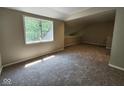 Spacious bedroom with plush carpeting and ample natural light from a large window at 70 Lookout Ridge Dr, Columbus, IN 47201