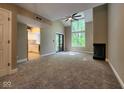 Inviting living room with vaulted ceilings, fireplace, and access to a modern kitchen at 70 Lookout Ridge Dr, Columbus, IN 47201