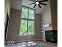 Bright living room featuring a fireplace, large windows, and custom shelving at 70 Lookout Ridge Dr, Columbus, IN 47201