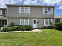 Well-maintained two-story home featuring a green lawn and tidy landscaping at 7445 Melanie Ln, Indianapolis, IN 46217