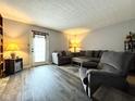 Inviting living room with neutral tones, stylish furniture, and wood-look flooring at 7445 Melanie Ln, Indianapolis, IN 46217