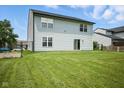 Large backyard with a lush lawn and secure fencing, offering ample space for outdoor activities at 7549 Stockard St, Indianapolis, IN 46239
