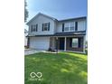 Two-story home featuring a two-car garage and well-maintained lawn at 7549 Stockard St, Indianapolis, IN 46239