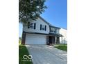 Two-story home with a two-car garage and manicured lawn at 7549 Stockard St, Indianapolis, IN 46239