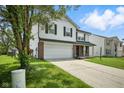Inviting two-story home with attached garage, brick accents, and well-manicured front lawn at 7549 Stockard St, Indianapolis, IN 46239