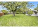 Spacious backyard with mature trees and lush green grass at 9010 Deer Run Dr, Indianapolis, IN 46256