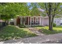 Quaint two-story home with a welcoming front porch, perfect for relaxing outdoors at 941 N Beville Ave, Indianapolis, IN 46201