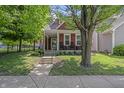 Beautiful two-story home with a charming front porch and well-maintained lawn at 941 N Beville Ave, Indianapolis, IN 46201