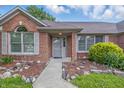 Inviting front entrance featuring a landscaped walkway and charming architectural details on a sunny day at 959 Harvest Ridge Dr, Avon, IN 46123