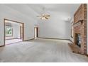 Bright, airy living room boasts neutral carpet and a striking fireplace creating an inviting atmosphere at 959 Harvest Ridge Dr, Avon, IN 46123