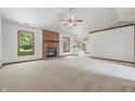 Spacious living room features a brick fireplace, neutral carpet, and bright windows with an airy feel at 959 Harvest Ridge Dr, Avon, IN 46123