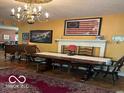 Elegant dining room featuring classic decor, hardwood floors, and ample natural light at 9701 Hamilton Hills Ln, Fishers, IN 46038
