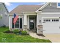 Inviting front porch and well-manicured lawn enhance this home's curb appeal at 104 Perlican Dr, Cicero, IN 46034
