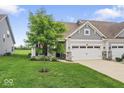 Charming home exterior with a well-manicured lawn and a two-car garage at 104 Perlican Dr, Cicero, IN 46034