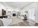 Bright living room with fireplace, built-in shelves, plush seating, and modern decor at 10479 Dusty Rose Dr, Zionsville, IN 46077