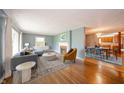 Bright and inviting living room with hardwood floors, fireplace, and seamless access to the kitchen at 105 Golf Club Rd, Anderson, IN 46011