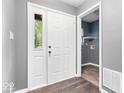Bright entryway with white doors, wood flooring, and gray painted walls at 12277 E Harvest Glen Dr, Indianapolis, IN 46229