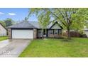 Charming single-Gathering home featuring a 2-car garage and a well-maintained lawn at 12277 E Harvest Glen Dr, Indianapolis, IN 46229