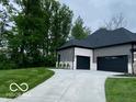 Exterior view of the property showing the attached garage, driveway and the home's architectural style at 12511 Lowery Way, Fishers, IN 46037
