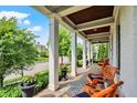 Inviting front porch with rocking chairs and decorative planters, perfect for relaxing outdoors at 12999 Deerstyne Green St, Carmel, IN 46032
